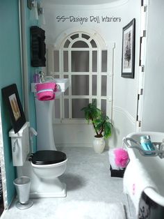 a doll house bathroom with toilet, sink and bathtub