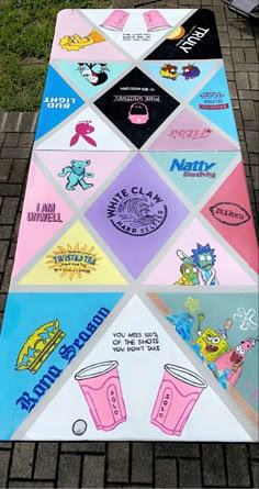 a colorful parking mat with cartoon characters and drinks on it, along side a brick sidewalk