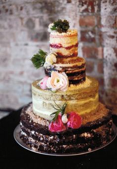 a wedding cake with flowers on top is featured in the instagram for this post