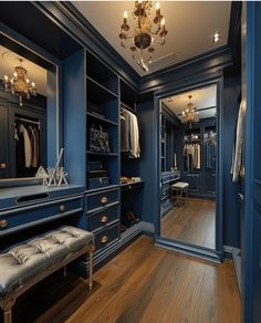 a walk in closet with blue walls and wooden flooring, chandelier hanging from the ceiling