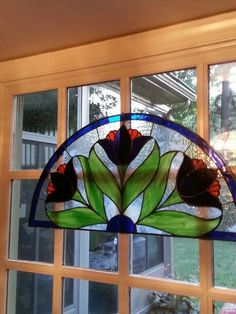 a stained glass window with flowers on it