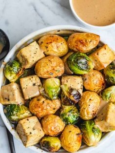 brussel sprouts and brussels sprouts in a bowl next to a cup of coffee