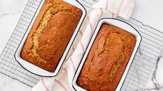 two loafs of banana bread sitting on top of a table next to each other