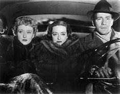 an old photo of three people sitting in a car