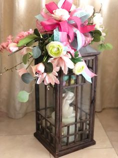 a vase filled with flowers sitting on top of a tiled floor next to a window