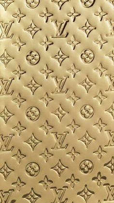 a close up view of the louis vuitton pattern on a gold plated surface