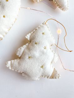 a white ornament with gold stars on it