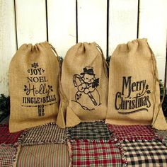 three burlap bags with christmas designs on them