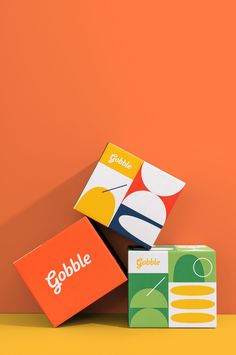 three colorful boxes stacked on top of each other with the word gobble printed on them