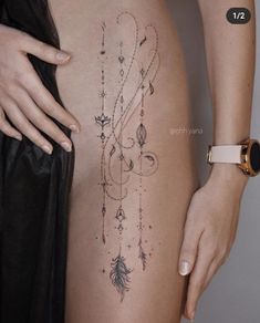 a woman's stomach with tattoos on it and an arrow in the middle,