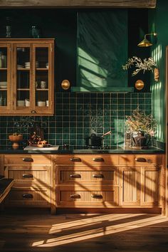 a kitchen with green tiles and wooden cabinets in the sun shining on the counter tops