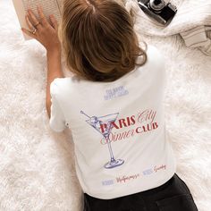 Paris City Dinner Club T-Shirt | Martini Glass Tee | Paris Lover Gift | Comfort Colors T-Shirt | Paris City Tee | Gift for Travelers | Street Style Tee | French Fashion Shirt | Casual Paris Tee | City Night Shirt | Travel Lover Gift | Oversized Paris Tee | Retro Paris Graphic Shirt Paris City Dinner Club T-Shirt featuring a martini glass design and "Paris City Dinner Club" text. Perfect for Paris lovers, foodies, and anyone who loves city nights. This soft, comfortable shirt is great for casual French Tshirt Design, I Love Paris Tshirt, Street Style Shirt, Paris Graphic, Club Tshirt, Boho Street Style, Paris Tee, Vintage Dinner, Dinner Club