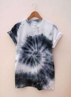 a black and white tie dye shirt hanging on a hanger