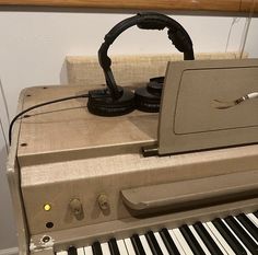 an electronic device sitting on top of a piano