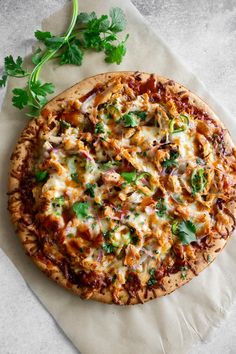 a pizza sitting on top of a piece of parchment paper