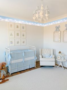 a baby's room with a crib, rocking chair and pictures on the wall