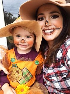 a woman and child wearing halloween costumes