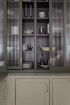 the cabinets in this kitchen have glass doors