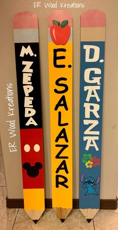 three wooden skis with different designs on them and the words disney world written on them