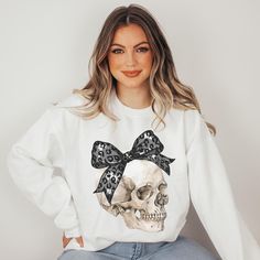 This Cute and Comfy Halloween Sweatshirt its the perfect addition to your fall weather or Halloween event. It's fall yall, look cute in our black ribbon or bow and get to look coquette and chick this holiday season.  * S I Z I N G * ♥️ Sizing is unisex so runs like men's, though not overly large ♥️Most women find their typical size works best. ♥️ Please see size guide in last listing photo for all measurements and information ♥️ 100% Soft cotton ♥️Design is high quality digital print ♥️ Wash and dry normally. Do not iron directly on the print. * S H I P P I N G * T I M E S * ♥️ Our items are individually made with love for each of our buyers. Items ship in 1-7 business days (typically 1-3). **REFUNDS/ EXCHANGES: - Due to our items being made to order, all sales are final, with no returns/e Cute Black Fall Sweater, Cute Black Sweater For Fall, Trendy Black Halloween Sweatshirt, Cute Black Fall Sweatshirt, Cute Black Sweatshirt For Fall, Halloween Pumpkin Patch, Halloween Coquette, Coquette Halloween, Skull Sweatshirt