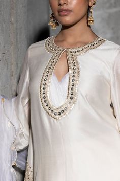 Ivory kurta adorned with shimmering metallic zari and sequin embroidery on neckline and hem. Paired with embroidered pant and pearl, white cowrie shell border embroidered dupatta. - Aza Fashions Scallop Kurta, Latest Blouse Patterns, Stylish Kurtis, Stylish Kurtis Design, Chanderi Dupatta, New Saree Blouse Designs, Kurta Set For Women, Neck Designs For Suits, Vacuum Storage