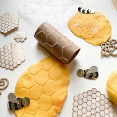 a paper roll sitting on top of a table next to bees and honeycombs