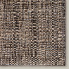 a piece of woven material with squares and lines on the bottom, in grey tones