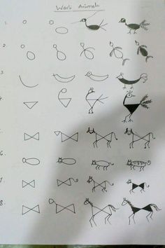 an image of some drawings on paper with numbers and symbols written in black marker pen