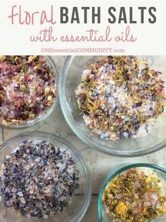 four glass bowls filled with bath salts on top of a marble counter next to the words floral bath salts with essential oils