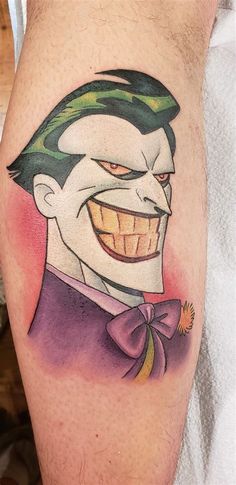 a man's leg with a joker tattoo on it