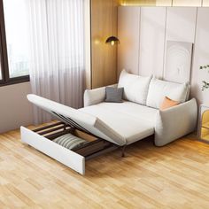 a white couch sitting on top of a hard wood floor next to a wall mounted mirror