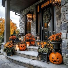 pumpkins and candles on the front steps of a house