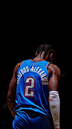 the back of a basketball player wearing a blue jersey