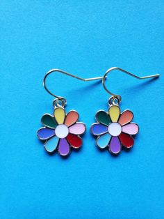 Do these multi color earrings bring a smile to your face? These  enamel rainbow/multi colored flower earrings are light weight and would match any outfit! Multicolor Flower Shaped Jewelry For Summer, Multicolor Flower-shaped Jewelry For Summer, Trendy Multicolor Flower Shaped Jewelry, Trendy Multicolor Flower Earrings For Summer, Multicolor Flower Charm Earrings For Gift, Colorful Flower Earrings For Spring, Cute Multicolor Jewelry With Ear Wire, Multicolor Summer Flower Charm Earrings, Summer Multicolor Earrings With Flower Charm