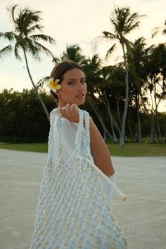 Handcrafted by artisans, the Talli Macrame Tote Bag is the perfect chic summer tote. Made from soft but sturdy 100% cotton in varying tones of cream and white, it features a braided shoulder strap and a removable satin liner bag. This open-knit tote is perfect for both beach days and evening strolls, offering versatile elegance. Macrame Tote Bag, Knitting Tote, Patchwork Top, Summer Tote, Macrame Bag, Boho Bags, Fringe Skirt, Personalized Clothes, Butterfly Sleeves