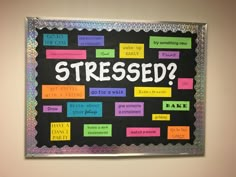 a bulletin board that says, what is stressed? with post it notes on it