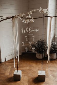 an image of a welcome sign on the floor with flowers and ribbons hanging from it