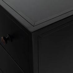 a black cabinet with two drawers and knobs