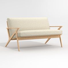 a white couch sitting on top of a wooden frame