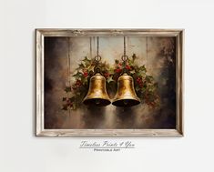 two bells with holly and red berries on them hanging from the ceiling in front of a white wall