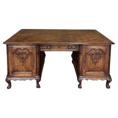 an old wooden desk with carved carvings on the top and bottom, against a white background