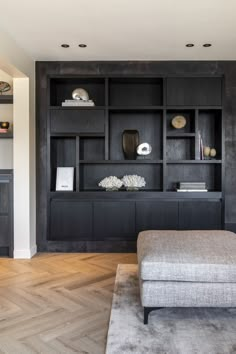 a living room filled with lots of furniture and bookshelves on top of it