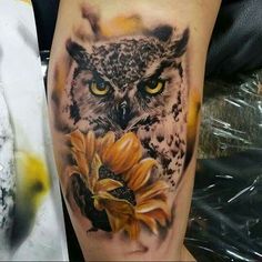 an owl and sunflower tattoo on the leg