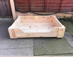 a wooden bed sitting on top of a sidewalk