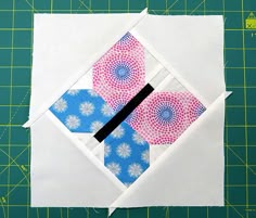 the block is made up of white paper with blue and pink designs