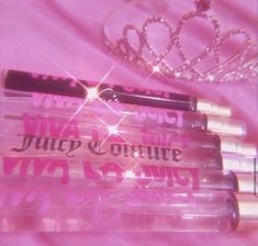 four lip glosses with a tiara on top