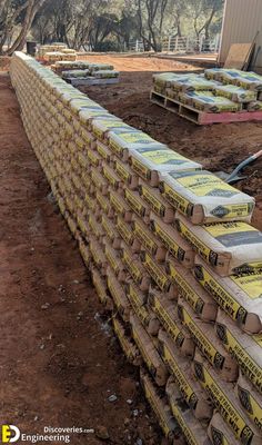 several boxes are stacked on top of each other in front of a building under construction