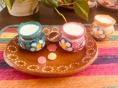 three candles are sitting on a decorative plate