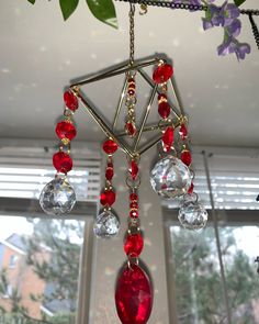 a chandelier hanging from the ceiling with red and clear beads