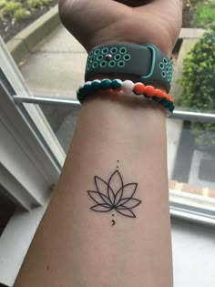 a woman's arm with a tattoo on it and a flower in the middle